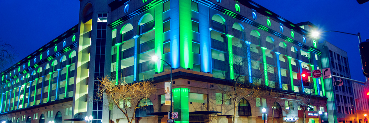 Evening photo of Sacramento City Hall Garage with blue and green lights