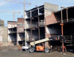 This image shows a construction project happening at the 700 K site, a crane is shown on the right side and the walls are undone in this stage of construction at that site.